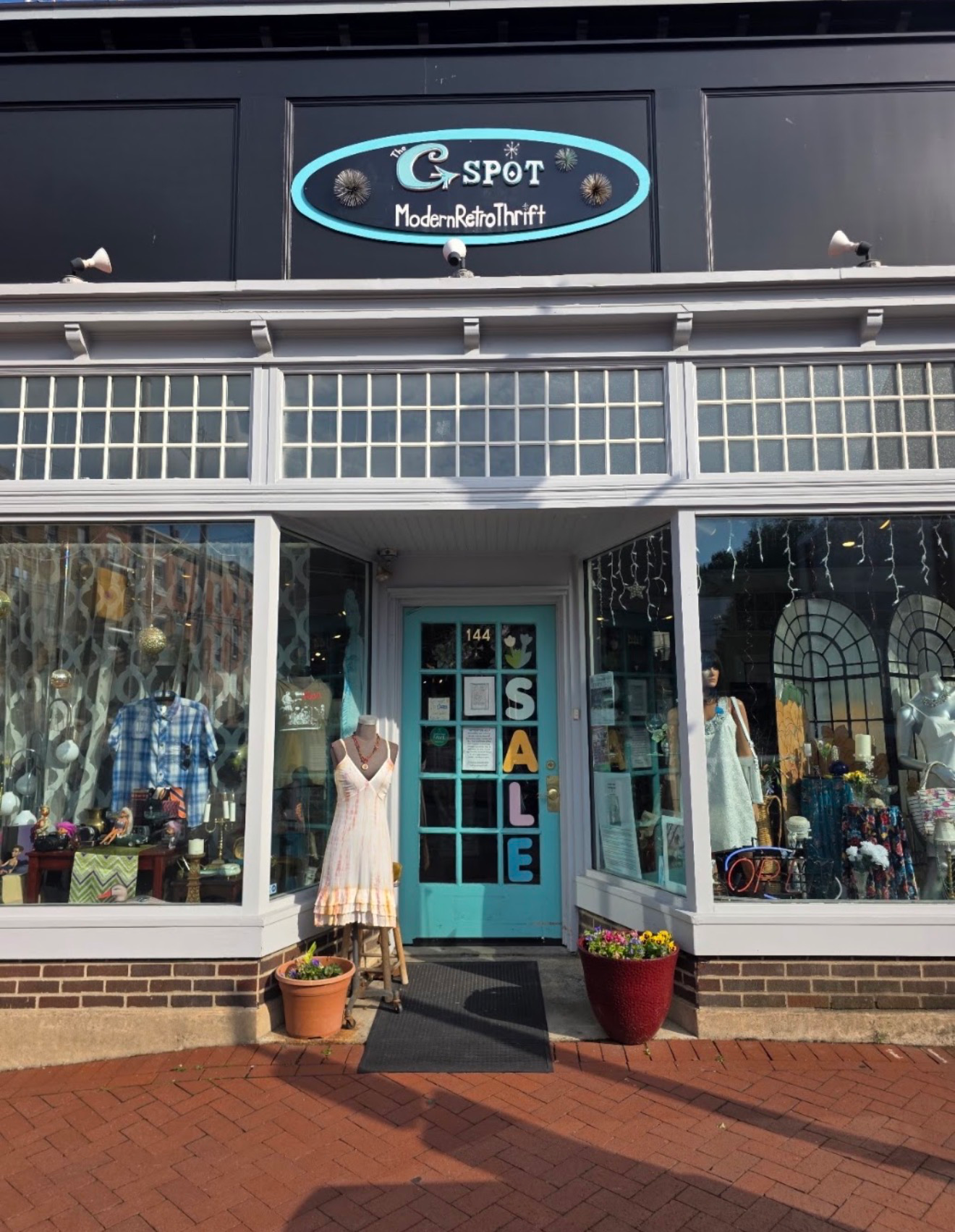 Light fixture installation at The G Spot Thrift Boutique